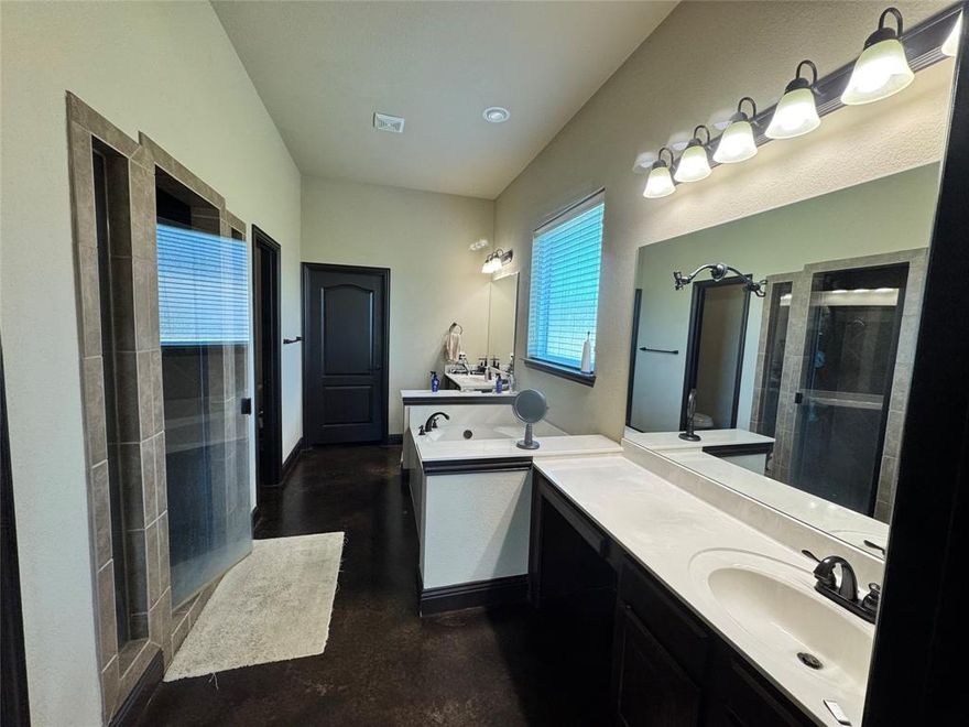 Discover refined living in this custom-built luxury estate on a premium 1+ acre lot in the exclusive Preserve Oaks community. Designed with craftsmanship, privacy, and sophistication in mind, this four-bedroom, three-bath residence blends timeless architectural detail with modern high-end upgrades.

Step inside to 11-foot ceilings, an expansive great room, and surround-sound theater system that elevate everyday living. Custom built-ins, stained concrete flooring, and a wood-burning fireplace create a warm, upscale ambiance ideal for both intimate evenings and entertaining.

The chef-inspired kitchen features slab granite countertops, premium appliances, an oversized walk-in pantry, and generous workspace perfect for hosting family dinners and large gatherings.

A private office with a separate exterior entrance offers convenience, discretion, and work–life balance.

Recent upgrades exceeding $100,000 include:
 • Brand-new roof
 • Energy-efficient commercial windows
 • Professional exterior repaint
 • New commercial gutter system

The three-car garage includes an oversized bay with 9+ ft clearance for trucks or recreational equipment.

Outdoors, a $30,000+ wrought-iron fence with automatic security gate ensures elegance and peace of mind. With over an acre, design the ultimate outdoor retreat—pool, workshop, or casita.

This estate blends luxury, security, and function—a private Texas home where craftsmanship meets comfort. Move-in ready and impeccably maintained, it invites you to a lifestyle of ease, quality, and prestige.