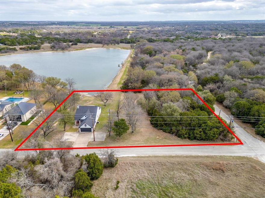 1451 Lakeside Trail, Whitney, TX 76692 — Rare Lakefront Home + Additional Lot in White Bluff Resort-
One-of-a-kind lakefront residence on White Bluff’s South interior lake, situated on nearly 1.5 acres (includes an extra lot to the south). Secluded, well-wooded two-story home with 3 bedrooms, 2 baths and approx. 1,994 sq ft of open-concept living. Stunning Lake Room-family room features a full wall of windows with panoramic lake view.  This home is perfect for entertaining. Main bedroom is on the main level; two bedrooms upstairs. Recent updates include fresh paint and new granite kitchen countertops. Use your yard for kayaks or paddle boats and enjoy catch-and-release fishing and frequent wildlife sightings. Move-in ready.  White Bluff resort amenities: pools, marina, golf, dining and more. Schedule your private showing today.