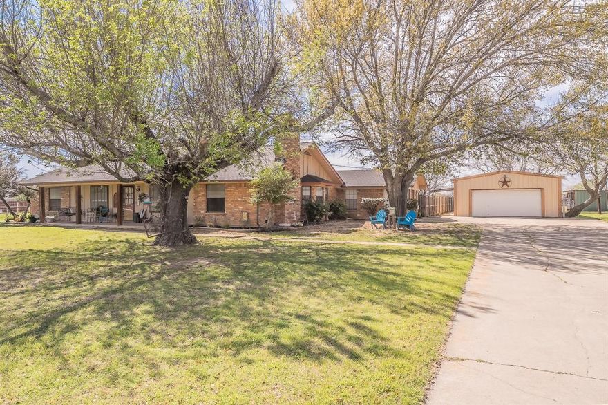 Exceptional opportunity to own a versatile 2.92 acre property in Fort Worth within Keller ISD, offering a rare combination of space, functionality, and convenience. The main home features 3 bedrooms, 3 full bathrooms, and 2,615 sq ft of well designed living space. A welcoming covered front porch (155 sq ft) and expansive covered back porch (440 sq ft) provide inviting outdoor areas for relaxing or entertaining. Inside, the large family room includes a vaulted ceiling and fireplace, creating a warm central gathering space. An oversized game room with wet bar and full bathroom offers flexible use as a potential 4th bedroom, guest suite, or entertainment area.Outdoor amenities include an inground gunite diving pool with slide, cross fenced acreage suitable for horses, and additional parking ideal for an RV or boat. The property also includes a 960 sq ft 2 car+ detached garage, providing abundant storage and workspace options.A standout feature is the impressive 4,200 sq ft metal buildingg located on the back acre. Built on a concrete slab and equipped with 210 amp electricity, a bathroom, and two offices, this structure is currently used as a commercial cabinet-millwork shop. Its size and layout offer exceptional potential for business operations, equipment storage, hobby use, or future customization.
This property delivers the space and flexibility to live, work, and enjoy a wide range of uses—all in a convenient location with easy access to nearby schools, services, and major routes. A unique offering with room to grow.
