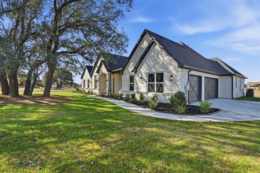 Located in the exclusive and highly sought after gated community of Silverado on the Brazos. With its masterful craftsmanship & sophisticated finishes, this luxury inspired 2,950 sqft home is exquisite. Enjoy the open concept floor plan that offers an inviting, cozy space, perfect for gathering and entertaining. Boasting sensational amenities & stunning features throughout, no detail was overlooked. Awe inspiring chef's kitchen with an expansive granite island. The living room is highlighted by coffered ceilings, Austin Limestone fireplace, stunning views, Beautiful primary suite with walls of windows, divine spa like bath with large shower and soaking tub. Split guest rooms. Office off the front overlooking lush oak trees. Cozy up to the fire while enjoy remarkable sunsets on the expansive outdoor patio with full outdoor kitchen or walk out to the pond and throw a line in the water. Texas dream 3 car garage that is big enough for a dually.  Silverado on the Brazos community features access to the Brazos River via private boat dock and ramps Perfectly situated between Weatherford and Granbury for convenience of shopping and fine dining.