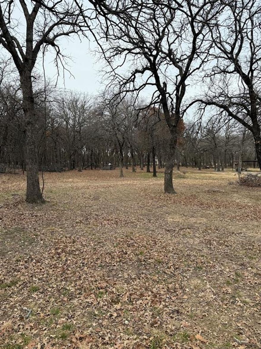 Rare, heavily treed, and just over an acre in the heart of Azle.  The space would make a beautiful homesite with room for a shop and pool. Platted, waiting final approval from the City. Septic, water, electric and driveway will need to be installed. Close to the Park, lake, shopping and schools with an easy commute to Fort Worth, Weatherford and Alliance area. Pictures Coming Soon!
