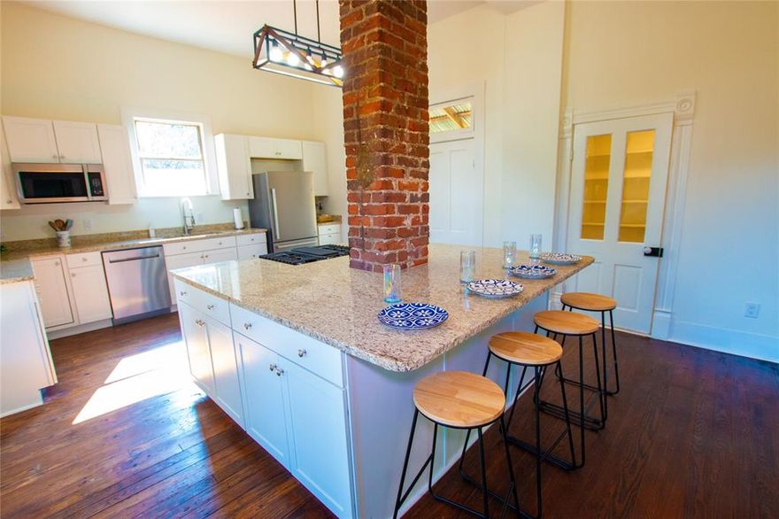 Historic District, the Doyle House is fully refurbished 1933 historic charm while incorporating modern conveniences. 3 bedroom, 2.5 bath, 2,457SF home PLUS a detached income producing 300SF studio. Formal living & dining rooms with tray ceilings, 2 fireplaces, & built-ins. Open-concept great room features high ceilings & new kitchen with statement island & storage, walk in pantry, new 4-burner gas range, dishwasher, refrigerator, & farmhouse sink. Back deck leads to outdoor entertainment with patio space, lawn, professional horseshoe pits, dart board, & fire pit. Restored original wood floors throughout. Spacious primary suite with a large sliding tri-panel closet & an en-suite bath with shower over original cast iron claw foot tub, dual sinks, & updated fixtures. Large secondary bedrooms. Dual efficient mini splits for heating & cooling, ceiling fans. Inside laundry. Concrete driveway.