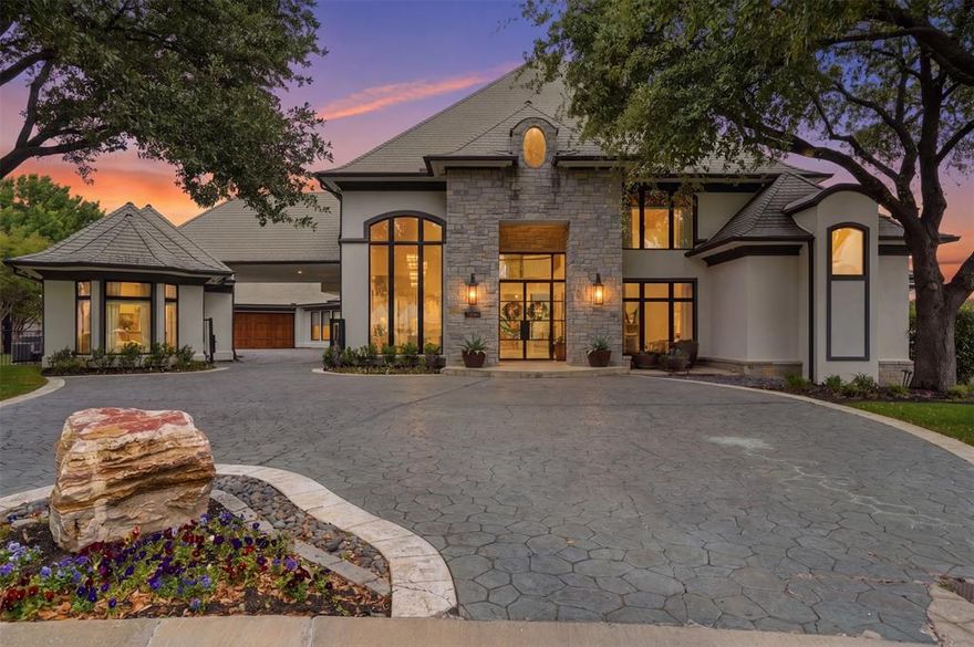 Refined, architectural elegance meets effortless luxury in this stunning estate, perfectly positioned on the 7th hole of Mira Vista Country Club with lake views. Every detail has been thoughtfully curated for both grand entertaining and everyday living. Set at the end of a cul-de-sac and framed by mature trees, the striking stone-and-stucco façade makes an unforgettable first impression.

Inside, soaring ceilings and expansive walls of glass flood the home with natural light, seamlessly connecting indoor and outdoor living. The main living area showcases a dramatic fireplace, wide-plank hardwood floors, and panoramic views of the resort-style backyard and golf course. A designer kitchen anchors the home with an oversized marble island, professional-grade appliances, custom cabinetry, and an open flow into multiple gathering spaces.

The primary suite is a true retreat, featuring a striking see-through fireplace shared with the spa-inspired bathroom, creating a serene, resort-like ambiance. The bath is wrapped in luxurious marble and includes a freestanding soaking tub and dual walk-in showers. All six generously sized bedrooms feature private en suite baths, offering comfort and privacy for family and guests alike. Additional living spaces include a sophisticated dining room with statement lighting and custom wall treatments and a private office with custom built-ins offer many flexible areas for work or leisure.

Separate guest quarters offer exceptional flexibility, complete with a full kitchen and full bathroom—ideal for extended stays, guests, or private flex space.

Step outside to your private oasis—an expansive patio, sparkling pool, gas fire pit, and manicured grounds overlooking serene green space create the ultimate setting for relaxation or entertaining under the stars.

With its seamless blend of modern sophistication and timeless design, this exceptional property offers elevated living at every turn.