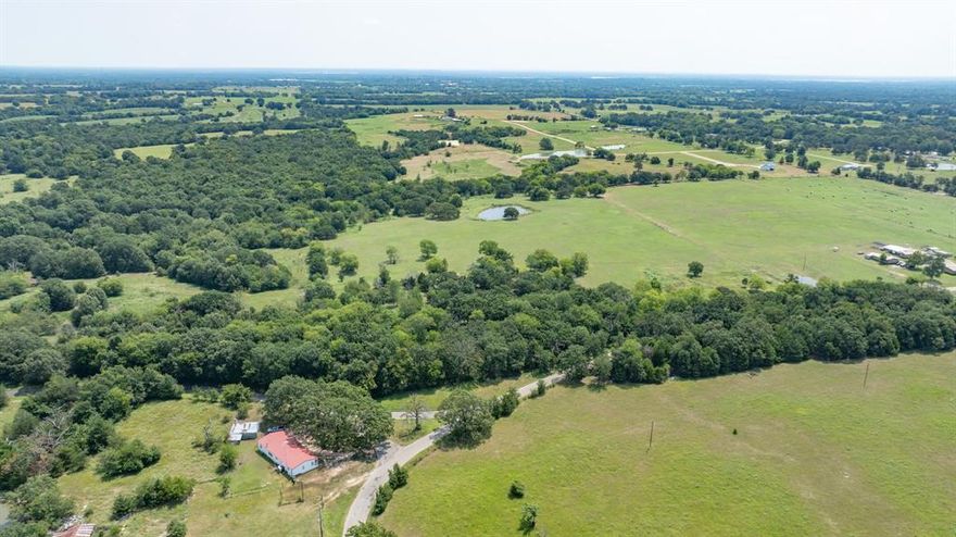 24.84 Acres- Ag exempt opportunity minutes from Lake Fork! Enjoy the peaceful rolling meadows of this well located property with easy access on CR 1730. About 1,200 feet of road frontage with Electricity and Co-Op Water line at the road. The Wilcox aquifer under this land is also a viable option for a well. This  60-40 pasture-wooden area ( Majestic Oak trees, Chinaberry, Mulberry, Osage orange) split is currently used for hay production and holds an Ag exemption. Ideal location for a Ranch, Homestead, Secondary Home- only 70 miles from Dallas or just recreational land- Whitetail Deer and Duck paradise. Enjoy fishing the stocked pond! Also for sale MLS 21025116 and 20954029. These lots  can be bought together for a total of 61.27 acres or 63.19 acres!