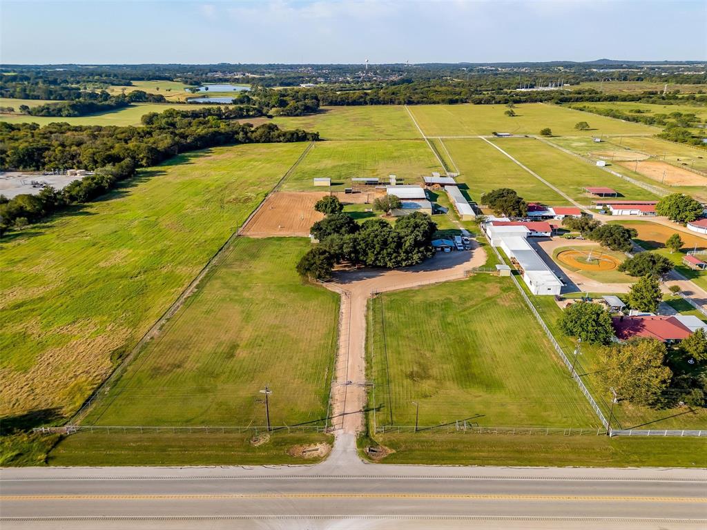 10 Acres and Another 10 Acre lot is available!!! Right Here in the Heart of Burleson, This 10 acre fully pipe fenced Turn Key Farm and Ranch property has lots to offer. Starting with the long driveway that separates two large turnout pastures with covered loafing sheds, to follow is the sprawling Ranch Style Home that accommodates, 3bedrooms 2full bath, 2family rooms a kitchen, that is the heart of the home, a dinning area, and so much more to offer. Every room feels very spacious. From the back of the home you overlook the 40 by 60 show barn that contains, concrete flooring 4 stalls a feed room, tack room and storage room, 2 wash racks located at the front of the barn and the back. A large 5,000 pound working grain bin attached. Another 40 by 60 barn that includes 3 stalls, a concrete walk way. This barn also holds a concreted area with a horse stock, sink , hot water heater, along with a 12 by 24 office that contains a restroom and shower. The third barn is a 20 by 30 fully inclosed hay barn. More stalls along the side of the property as well. Holding a total of 30 horse stalls and 10 outdoor pens that each have a loafing shed for cover. This Ranch also holds a 55ft covered round pen, 6 horse walker, 250 by 125 piped riding arena. If you think it didn't already have everything well it does, it also has a large 5 acre pasture that can be used to produce hay or for turnout. This Ranch has hosted many Burleson FFA and 4H judging practice shows, given lots of riding lessons, boarded horses and used as an equine breeding facility. The Income or Investment potential is Unlimited Here, being minutes from Burleson with all the amenities, but yet still outside of the city limits. You can use this Property for Income or just be kept to yourself to enjoy the peacefulness it has to offer. Schedule that showing today!! Serious enquires only please.