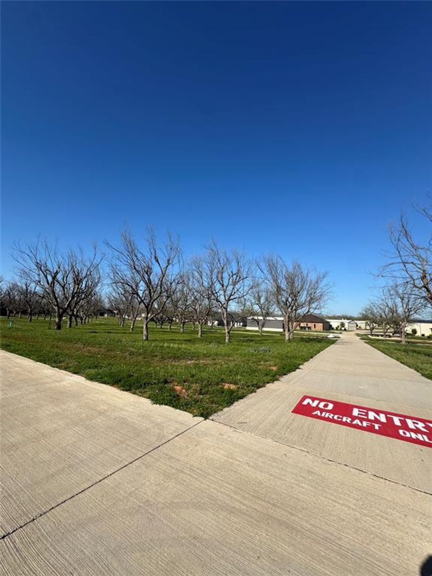 FLY IN & SEE THIS READY TO BUILD LOT BEFORE IT’S GONE! IF YOU NEED EVEN MORE ROOM, THE ADJOINING LOT CAN BE PURCHASED TO GIVE EVEN MORE SPACE TO DESIGN YOUR DREAM HOME AND HANGAR!! See MLS#:20890615 This lot is very unique in that the taxiway is on 2 sides of the lot allowing you the opportunity to chose the direction of the hangar entry. The creek on the backside of the lot offers additional privacy space. The Landings Airpark in Pecan Plantation features a 3,100 x 50 ft paved runway, concrete taxiways, and a new self-serve fuel station area with tie downs. Landings has paved roads, electric, High-speed internet, water, and sewer service available. There is no time limit to build and hangars may be constructed with your residence but may not be built prior to the construction of your home. 2,000 SF home min. Pecan offers amenities of 2 golf courses, 2 air parks, marina, stables, clubhouse with hotel & restaurants, river access with parks, 2 pools, activity center with pickle ball, tennis courts, dog parks and more! A MUST SEE!!