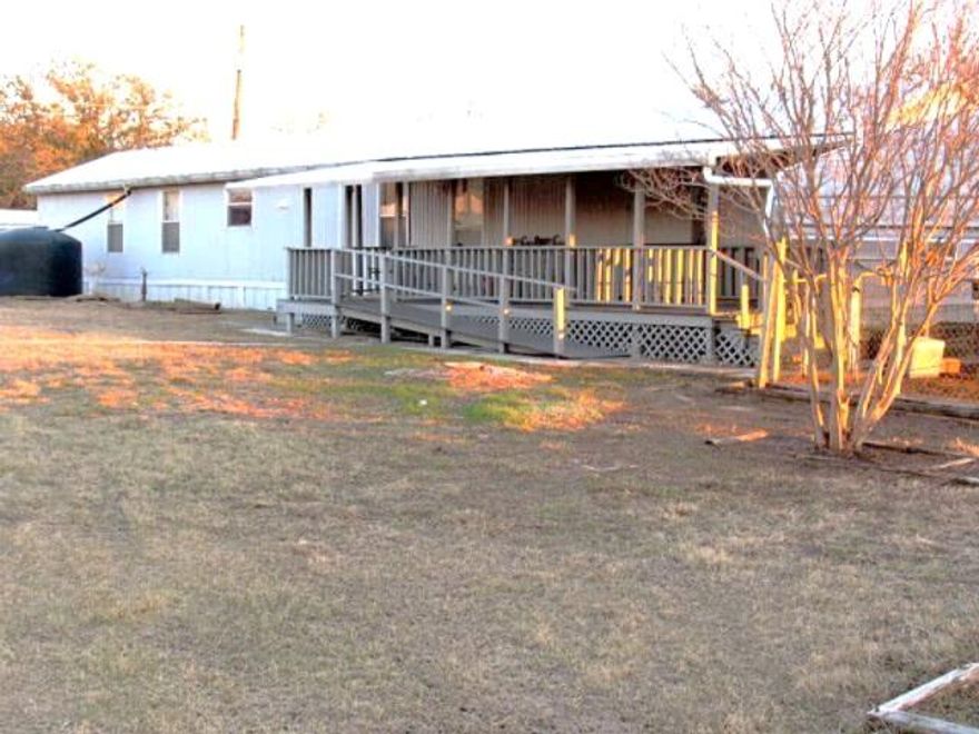 This 3-bedroom, 2-bath home is ideal for anyone seeking space, storage, and a large lot.
-  Four Lots Totaling 0.688 Acres offers plenty of room for outdoor activities, gardening, and expansion.
-  Multiple Covered Decks enable you to enjoy outdoor living and entertaining on both the front and back of the home.
-  Workshop and Garages.  An extra-large workshop, a separate 2-car garage, and a lawn equipment shed provide exceptional storage and project space.
-  Multiple Roll-Up Doors make easy access for vehicles, equipment, and materials.
-  Updated HVAC System (outside unit was replaced in 2021).
-  Metal Roof provides long-lasting durability and protection.
-  Rainwater Collection System which includes gutters and multiple storage tanks for sustainable gardening.
-  Greenhouse and Multiple Out-Buildings and Sheds. Perfect for hobbyists, gardeners, and those needing extra space for equipment, tools, and supplies.
-  3-Car Carport offers plenty of covered parking for vehicles.
-  Appliances, Shop Equipment, and Lawn & Garden Equipment will convey.