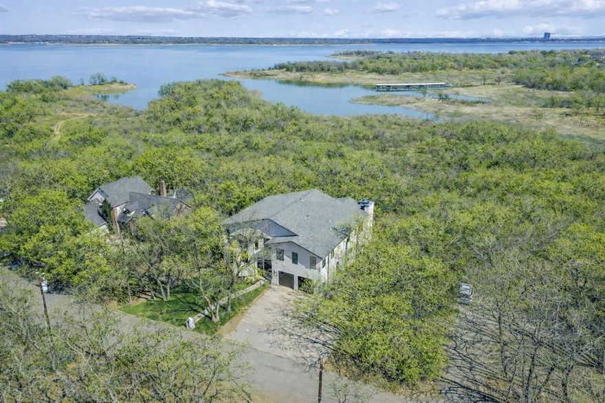 Prized Location! GRAPEVINE LAKE with Corps of Engineers land as your backdrop, plus coveted CARROLL ISD SCHOOLS! An expansive 0.749-acre lakeside retreat delivers the ultimate lifestyle experience, with lake access, scenic trails, and a stunning water view, all crafted for those who crave privacy, natural beauty, and a true resort-like atmosphere. This custom home is thoughtfully designed for effortless living and unforgettable entertaining. The heart of the home is a chef's kitchen featuring Viking appliances, three versatile islands, and a spacious open-concept layout that connects indoor living to the natural beauty just beyond your windows. The upper terrace sets the stage for slow mornings with coffee or unforgettable evenings by the fire, while the oversized deck is ideal for BBQ's and gatherings! All four bedrooms are private Ensuite, generously sized with walk-in closets, and the expansive primary suite offers a true retreat. Two spacious living areas offer plenty of room to spread out, gather, or unwind. The private, fully equipped office offers an ideal work-from-home setup, while dedicated built-in desk space in the bedroom area provides convenient room for homework or everyday tasks. Natural light pours through plantation shutters, framing peaceful views of mature trees from every window and giving the home a calm, tucked-away feel. Out front, enjoy the beauty and ease of low-maintenance artificial turf, plus the convenience of an oversized driveway. This one-owner home is a true celebration of elevated, mindful living in one of North Texas's most scenic cities and neighborhoods. This unique property offers a rare chance to experience lake living, all within minutes of DFW Airport, Shopping & Meadowmere Park. NO HOA!
The home was beautifully refreshed with new indoor and outdoor paint, windows throughout, and primary bath renewed.
MOVE-IN READY! *This Home is More than a Home, it's a Retreat!*