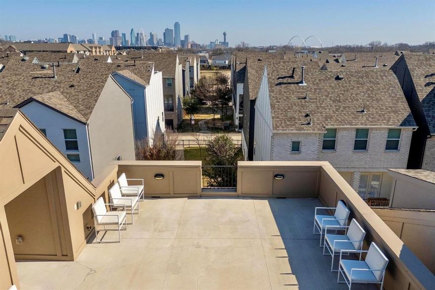 Don’t miss this highly versatile floor plan spanning 3 stories & multiple private outdoor spaces, including a huge rooftop deck with stunning skyline views! Built in 2022, impeccably maintained & thoughtfully updated. This like-new home boasts amazing natural light & stylish finishes throughout, with high ceilings & an open main floor that seamlessly blends living & dining spaces. Gorgeous gourmet kitchen equipped with a large island, pantry & SS appliances including a Samsung smart refrigerator, gas range & vented hood. Double doors off the living room open to a private covered balcony with park views! Laundry is conveniently located upstairs between both bedrooms (each with ensuite baths). Primary suite features dual sinks, a huge walk-in shower & tons of storage space. Remaining bed & bath on first floor could be used as an in-law suite, office or media room (tons of flexibility!) with direct access to a private side yard & the 2-car garage. Custom features include wood panelling installed in the primary, living room & half bath, custom kitchen cabinet hardware, sink in half bath + bathroom mirrors on first & second floors. Other updates include a sliding glass door installed for the bath tub & all toilets replaced. SoHo Square residents enjoy a plethora of neighborhood amenities, with access to a chic community lounge (complete with a kitchen), fitness center, pool + spa, bowling alley, golf simulator & game room. Don’t miss this stylish 3-story home in a convenient Dallas location, close to major highways, schools & parks, minutes to Downtown Dallas!