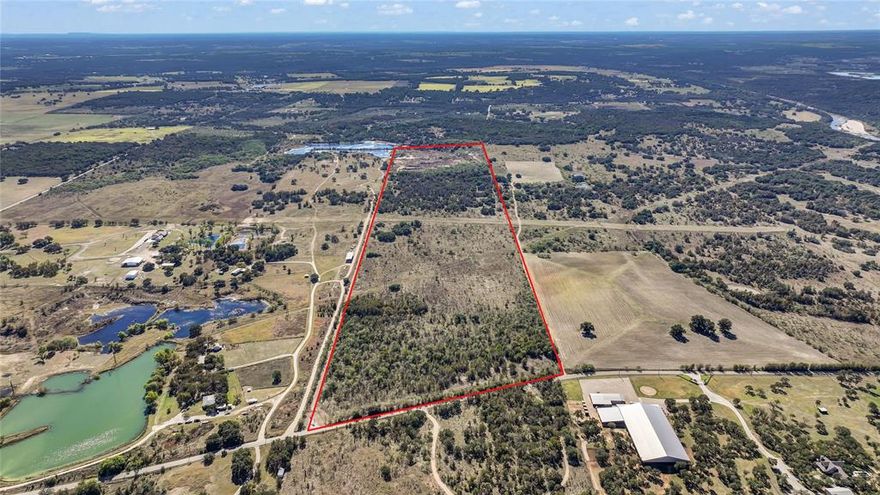 Multiple excellent homesite locations on 93 acres with 913 feet of road frontage on Grindstone Rd, many hardwood trees on the property and some mesquite, cleared areas and varied topography, minutes away from Brock schools.  Property can be bought as one platted parcel now however owner is in the process of subdividing and price will increase once subdivided. A 16-foot-wide gravel road, graded and compacted, with over 12 inches of base, borders approximately two thirds of the eastern side of property, then cuts through the middle and continues to the back portion of the property.   Back 28.36 acres of the property was previously used as a rock quarry, creating three stock ponds at back of property and has the potential to be converted into a recreational area. All information in this listing is deemed reliable; however, buyers and their agents are advised to verify all details independently.