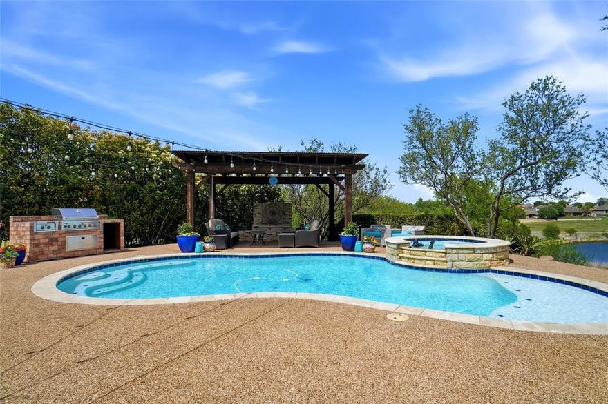 Nestled on .5865-acre cul-de-sac lot, this exceptional home offers a rare combination of privacy, space & scenic beauty. Backyard is a true showstopper with breathtaking views of tranquil pond & backing to a lush greenbelt.  Backyard oasis features saltwater pool & spa combo designed for both relaxation & entertaining. Enjoy the outdoor fireplace for cozy evenings or unwind beneath the covered pergola while enjoying the ambiance of outdoor lighting & tranquil surroundings. Outdoor kitchen has built-in grill, warmer & 2 burners—perfect for hosting family & friends. Enjoy direct access to picturesque walking trails, creating a seamless connection to nature. This 3 bedroom 2 bath with large enclosed sunroom offers a versatile floorplan with split bedrooms. Kitchen boasts quartz countertops, soft-close cabinets, moveable island, wine refrigerator & more! Primary bedroom has French doors to private patio, large walk in closet & luxurious soaking tub in primary bath to unwind after busy days. Large living area features corner gas fireplace with gas logs & remote control for easy use, crown molding, ceiling fan & abundance of windows to enjoy spectacular view. Enjoy the peaceful sound of the spa waterfalls through the sliding glass doors or sliding screen doors from the sunroom currently being used as an office, but bring your imagination to make it your perfect sanctuary, workout room or 4th bedroom. Laundry features Stainless Steel sink & lots of cabinets. This home delivers the ultimate in comfort, privacy & outdoor living. You will come home to paradise every day when you live here! Must See Today!