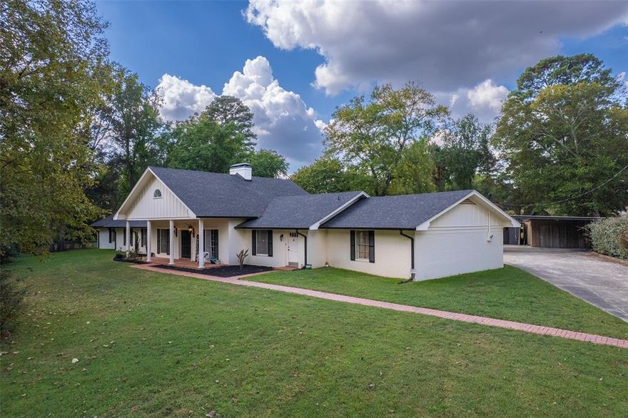 Welcome to 1010 S. Williams Avenue, an exceptional feature home in the prestigious Dellwood Park area of Mt. Pleasant. Set on more than two beautifully manicured acres, this property is graced by magnificent mature oaks that create a sense of privacy, elegance, and timeless East Texas charm. With 5 bedrooms and 4 full bathrooms, plus an upstairs bonus space offering endless possibilities for a media room, private office, or guest retreat, this home was designed for both comfort and versatility.

The kitchen is a true chef’s workspace, thoughtfully laid out for entertaining and everyday living. The classic brick flooring throughout the main living areas adds warmth, character, and enduring style that never goes out of fashion. Step outside to a fully fenced backyard shaded by towering oaks, complete with a dedicated dog run and generous outdoor space ideal for relaxing or hosting on warm summer evenings.

The property also features two shop or storage buildings, along with a newly constructed gym or work area, offering rare flexibility for hobbies, fitness, or additional workspace. Ideally located near schools and churches, and just seven minutes from the award-winning Titus County Regional Hospital, this home blends luxury, livability, and location. Thoughtfully built, impeccably maintained, and increasingly hard to find, this is a home that stands apart in every way.