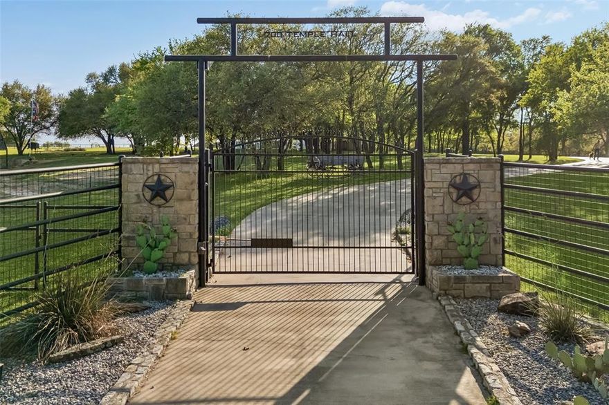 Tucked behind private gates on 18.5 acres, this distinguished Granbury estate delivers a rare combination of luxury living and ranch life—all just minutes from the town square. The custom stone residence spans over 7,300 square feet and was designed for both everyday comfort and large-scale entertaining. Expansive living areas, a dedicated media room, and a game room create a seamless flow, while the outdoor spaces—complete with a resort-style pool and outdoor kitchen—extend the living experience beyond the home. Equestrian improvements are equally compelling, featuring a well-designed barn with 14 stalls, multiple fenced pastures, and loafing sheds. A separate foreman’s home and guest house offer versatility for staff, guests, or multigenerational living. Recent updates and thoughtful upgrades throughout the property include new windows, updated appliances, quartz surfaces, wood flooring, and a fully integrated security system. A reinforced safe room provides added peace of mind. The land itself is both beautiful and functional, with a pond, mature hardwoods, and carefully maintained, low-maintenance landscaping. A solar power system with Tesla battery backup adds a forward-thinking element of efficiency and sustainability. Additional features include an oversized shop, fiber optic internet, and a private circular drive that enhances both convenience and curb appeal. A property of this caliber—offering privacy, usability, and proximity to Granbury—is increasingly hard to find.