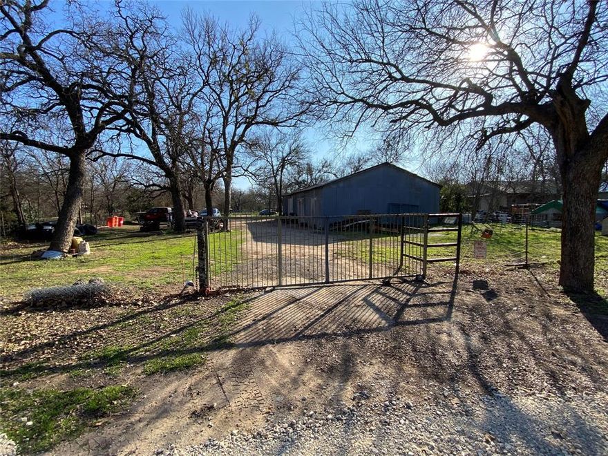 Great property tucked into the NW side of Mineral Wells that's close to downtown. Property could be used for a variety of purposes. It currently has a large workshop with electric, water, & sewer. It could be divided into 4 lots and developed into residences or left as it is.