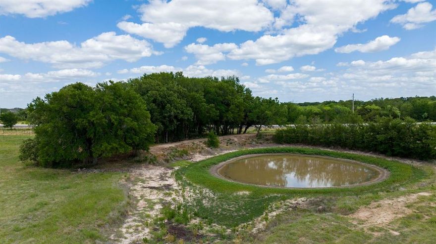 Located at 8526 FM 1744 in Hico, Texas, this exceptional 33.673-acre tract offers prime estate and commercial potential in one of the most sought-after areas of Hamilton County. Ideally positioned with improved access off both Highway 281 and FM 1744, the property sits centrally between Hamilton, Hico, and Stephenville, home of Tarleton State University, making it a strategic investment opportunity with excellent visibility and accessibility. The seller has developed a comprehensive concept plan for a vineyard and wine-tasting facility with full-service RV accommodations, available upon request and previewed in the listing photos.

The property has been thoughtfully improved and is ready for continued development. A 502-foot commercial water well with a 4-inch casing and a 5-horsepower pump serves the property, along with two 2-inch water lines installed within 5 feet of the interior fence line and additional 2-inch lines servicing the RV sites. Approximately four acres are planted in established vineyard production, consisting of 70% Syrah and 30% Picpoul Blanc varietals. There are 14 full-service, pull-through RV spaces, spaced 30 feet apart, each with a separate entrance off FM 1744 and connected by a 25-foot driveway, with septic already in place. A stock pond, scattered mature oak trees, extensive clearing, and a newly constructed caliche road system throughout the property further enhance usability and curb appeal.

Hico continues to thrive as a charming Central Texas destination, often compared to Fredericksburg's early growth days. With its growing collection of boutiques and restaurants and steady traffic between Fort Worth and Austin, the area presents strong long-term potential for commercial and hospitality ventures.