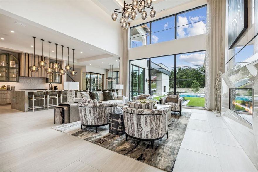 Award Winning Heritage Homes and designer Susan Semmelman have delivered this architectural masterpiece which embodies the pinnacle of luxury living. Exquisite finishes, modern amenities and the highest caliber of quality and comfort with unparalleled living space, meticulous craftsmanship and attention to detail throughout. A true chef's kitchen with professional grade appliances, quartzite countertops, oversized island with waterfall edges and catering kitchen. First floor features luxury owners suite complete with private coffee bar and a true his her ensuite spa experience with separate showers, vanities, toilets and custom designed walk-in closets. Two additional guest en suite bedrooms located on the first floor. The downstairs game room features a one-of-a-kind handcrafted Island from petrified wood. Cozy media room opens to a spacious game room. Front & rear courtyards with incredible water fountain, custom pool, and covered entertaining area. Can be purchased fully furnished!