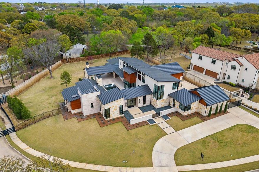 Modern masterpiece in the desirable Moss Farms of Southlake! Built by Atwood Custom Homes. Exceptional floorplan with versatile living spaces and an abundance of natural light throughout. Inviting entry, designer lighting and fixtures, and attention to every detail. The gourmet kitchen opens to the massive great room and is perfect for entertaining. Elegant formal dining room with adjacent wet bar with wine coolers. The dreamy master suite offers a wall of windows overlooking the property and a cozy fireplace. The luxurious master bath features a massive walk-in shower, elegant vanity, soaking tub, and dual custom closet. Recent addition of upstairs bonus room. Gorgeous outdoor living area with fireplace, built-in grill, and overlooking the sparking pool and spa for year-round enjoyment. Featuring a Savant home automation system. Spacious one-acre lot in a gated neighborhood. Easy access to DFW International Airport.