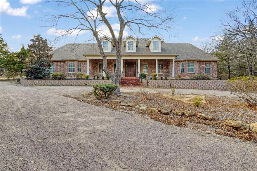 Seller willing to offer concessions or financing incentives! Your luxury lifestyle awaits with this incredibly well cared for brick estate in Summit Oaks, Denison's sought-after gated community halfway between downtown Denison and Pottsboro - just minutes from lake Texoma. No detail was spared in the design of this sprawling brick 5 bed, 6 bath house on a hill. Impeccable craftsmanship shines through the custom woodwork throughout. Right off the front entry is a spacious office or study room, opposite the formal dining room with decorative lighting and built-in serving bar. The living areas boast beautiful hardwood floors, natural & recessed lighting, high ceilings with crown molding, & custom wood built-ins including a wet bar. Chef's kitchen with top-grade stainless steel appliances, pot-filler, and a plethora of cabinet space. Breakfast area adjacent to kitchen sits right off the indoor brick porch with floor-to-ceiling doors & windows and built-in grill. Master bedroom features a private outdoor porch with treetop views, massive walk-in closet with endless storage, cedar closet, and ensuite bath with walk-in shower, jetted tub, and stained-glass window. Two separate staircases lead upstairs to bedrooms, bonus room, bathrooms, and movie theatre. While you're up there, don't miss seeing the incredibly well-insulated attic complete with spray foam insulation. This beautiful property sits on an acre with a large backyard, shaded wood pergola, brick patio & beautiful landscaping. Solar panels are owned and convey with the property, and utility bills are very low considering the size of the home! Ask agent for utility bill info. Pool renderings are also available. This is a one of a kind property! Call your favorite Realtor and schedule your viewing today.