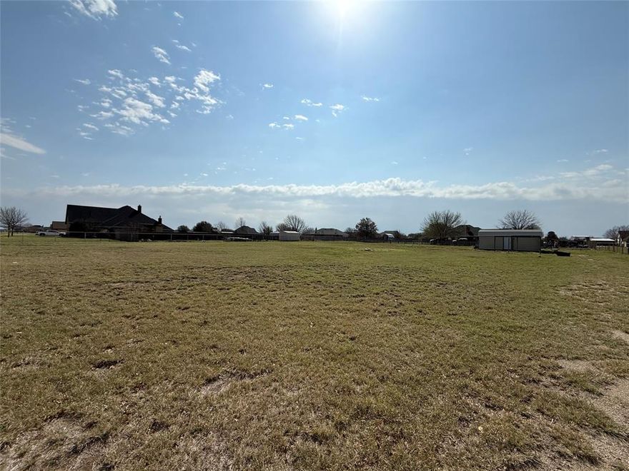 Discover the perfect place to build your dream home on this beautiful 1-acre lot tucked away on a quiet cul-de-sac in the highly desirable Pack Saddle Prairie neighborhood. With no HOA, you’ll enjoy the freedom to design and build the home you’ve always envisioned. Located outside the city limits, this property offers the best of both worlds: peaceful country living with no city taxes, while still being just a short drive from town for everyday conveniences. Imagine starting your mornings with coffee on the porch, taking in wide-open Texas skies, and ending the day with sunsets that never disappoint. The spacious acre provides plenty of room for a home, shop, pool, garden—or all of the above. Whether you want a large backyard for entertaining, space for hobbies and projects, or simply room to spread out and enjoy the quiet countryside, this property gives you the flexibility to make it happen. Situated in Wylie ISD, this lot combines a desirable location with the charm of rural living and the convenience of nearby amenities. If you’ve been searching for the perfect place to build where you can enjoy a little more space, a little more peace and quiet, and a lot more freedom, this could be the one.