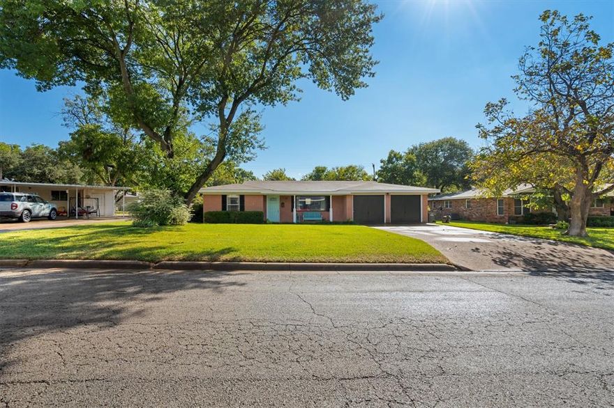 Charming 4-bedroom, 2-bath home in the heart of Graham, TX! Enjoy the welcoming front porch and manicured lawn out front. Inside, this Ranch-style farmhouse inspired home offers a cozy living area with a stunning picture window, faux-hardwood floors and a bright, comfortable feel. The kitchen features stainless steel appliances, plenty of cabinet and counter space, and a family-friendly dining area. The laundry area off the kitchen within the 4th bedroom makes for comfortable laundry access and includes ample storage space with a large walk-in closet. The primary suite includes a bright, private en-suite bath. Relax or play in the spacious backyard with covered patio— perfect for gatherings and Texas sunsets. New HVAC (2022), New electrical panels, New carpet, Updated paint throughout, New patio cover, and Emergency gas space heater added for back-up heating option. Conveniently located near schools, parks, and local shops, this move-in-ready home is full of small-town warmth and charm!