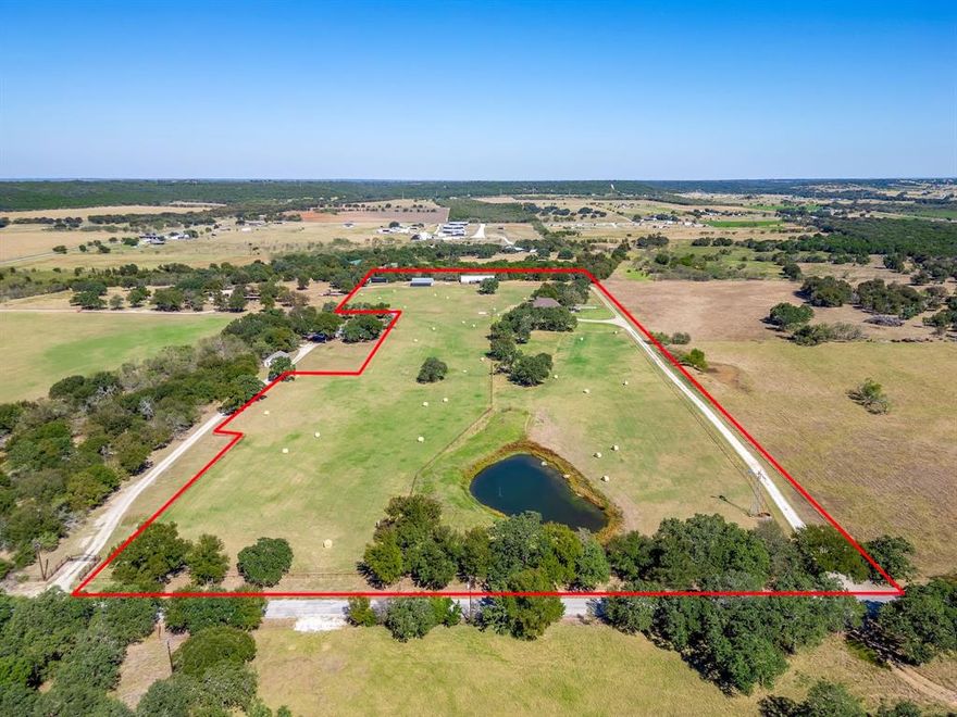 Built like a fortress, this extraordinary custom home sits on nearly 16 acres of sandy soil in the heart of North Texas horse country, just minutes from Weatherford, the Cutting Horse Capital of the World.  40+ GPM WATER WELL - Hard to find in North Texas!

The stunning great room features 25+ foot cathedral ceilings, exposed beams, and a massive floor-to-ceiling stone fireplace, creating a dramatic gathering space overlooking the coastal pasture.

The chef’s kitchen is built for entertaining, centered around a massive island and featuring a KitchenAid 8-burner gas range with double ovens, plus a wine fridge and built-in ice maker, surrounded by custom hickory cabinetry and ample counter space.

The home offers 5 bedrooms (including an office that can serve as a bedroom), 3.5 baths, a gym, formal dining room and more.

Built with exceptional durability, the home includes 2x6 framing on 16-inch centers, spray foam insulation, and a foundation supported by 30 piers drilled into bedrock. Additional highlights include 18-inch beams, 1-inch plywood flooring upstairs, and a Western Red Cedar and Austin Stone exterior.

Recent improvements include fresh interior paint, updated bathrooms, refinished stairs, new kitchen countertops, epoxy garage floors, and landscaping upgrades. Major updates include a new roof in 2024 and brand new main HVAC unit in 2026, plus two tankless water heaters, three HVAC systems, and a Generac backup generator.

Enjoy outdoor living with a new heated pool and spa. The property is fully fenced and cross-fenced with pipe fencing and features 15.948 acres of coastal bermuda pasture, three barns or shops with water and electricity, four horse stalls, a stock tank, and windmill structure with additional water well (condition unknown).
Properties of this quality are rare in North Texas. Schedule your private tour and experience this exceptional ranch estate. All info is deemed reliable but not guaranteed and should be verfied by buyer.
