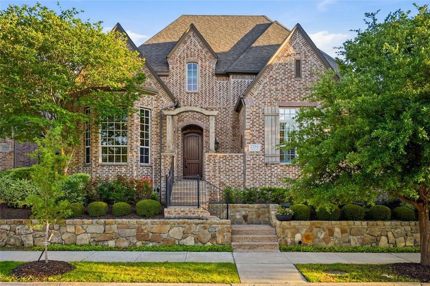 Stunning Tudor-style home in the sought-after Austin Waters community, built by Highland Homes and offering an exceptional, family-friendly floor plan with abundant flex space. This light-filled home features a dramatic entry with custom front door, vaulted ceilings, and hand-scraped wood flooring throughout the main living areas. Designed for both everyday living and entertaining, the layout includes a dedicated office, spacious game room, media room, and an additional flex workspace with built-ins off the kitchen and breakfast area.
The home offers five bedrooms, including Jack-and-Jill secondary bedrooms, along with a luxurious primary suite featuring a spa-like bathroom and an oversized walk-in closet. Recent interior paint enhances the bright, inviting feel, complemented by plantation shutters throughout.
Step outside to a large covered patio with outdoor kitchen, perfect for entertaining, along with a private rear-entry driveway, motorized gate, board-on-board fencing, and a three-car garage with additional parking space.
Ideally located in a family-friendly neighborhood with parks, playgrounds, and green spaces nearby, and just minutes from Legacy West, Grandscape, and The Star, with easy access to major roads, shopping, dining, and entertainment.