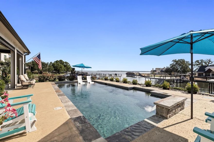 Simply stunning lake house for the discriminating buyer who wants to walk right in and enjoy!  There’s not a to-do list on this one; they custom-built and thought of everything and more!  Located in one of Cedar Creek Lake’s newest gated neighborhoods on the west side of the lake, for a quick commute from the metroplex, you’ll love the lock-and-leave lifestyle.  The open floor plan flows right on out to the dreamiest outdoor living spaces to make entertaining a breeze.  The outdoor space has remote control screens for shade or enclosing the space, then overhead radiant heaters and an outdoor fireplace making this a space for all seasons.  The primary suite downstairs overlooks the lake and has a spa-worthy bathroom.  Kitchen is as beautiful as it is functional with quartz countertops, cabinets, and storage galore, a 6-burner gas cooktop, and the heart of the kitchen is a 4’ x 8’ foot island!  Upstairs is a second living area with 2 bedrooms, a bunk room, an office space, and a balcony with miles and miles of lake views.  The pool overlooking the lake is the gem of the lakeside yard, which has a new steel retaining wall, boathouse with Trex decking and touchless cover for boat, plus add’l lift for Sea Doo.  Contact agent for the full list of upgrades & available furnishings.