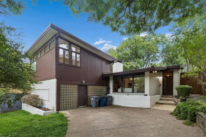 Tucked into the heart of Lakewood on an elevated homesite, this distinctive mid-century modern residence blends timeless architecture with a warm, inviting atmosphere. Surrounded by mature trees and thoughtfully positioned to capture natural light and beautiful views, this home offers a rare opportunity to enjoy classic design in one of East Dallas’ most sought-after neighborhoods. Just moments from White Rock Lake, enjoy easy access to scenic trails, outdoor recreation, and all of the charm that makes Lakewood such a desirable place to call home. Inside, expansive windows and an open, flowing floor plan create bright, comfortable living spaces designed for both everyday living and entertaining. Rich hardwood flooring and architectural details add character throughout, while the spacious layout offers a seamless connection between living, dining, and gathering areas. The kitchen was renovated in 2022 and is designed with functionality and style in mind, offering generous workspace and storage for effortless daily living.The private primary retreat provides a peaceful escape, while additional bedrooms and flexible living spaces offer versatility for guests, a home office, or hobbies. Every room feels connected to the surrounding landscape, bringing the outdoors in and enhancing the home's relaxed, welcoming feel. Step outside to your own backyard retreat where a sparkling pool and beautifully landscaped setting create the perfect environment for entertaining, relaxing, or enjoying quiet evenings under the trees. Whether hosting friends or enjoying a peaceful morning coffee, the outdoor spaces feel like a true extension of the home. Zoned to highly sought-after Lakewood Elementary, this exceptional property delivers the best of East Dallas living with timeless mid-century character, inviting indoor and outdoor spaces, and a premier Lakewood location near White Rock Lake.