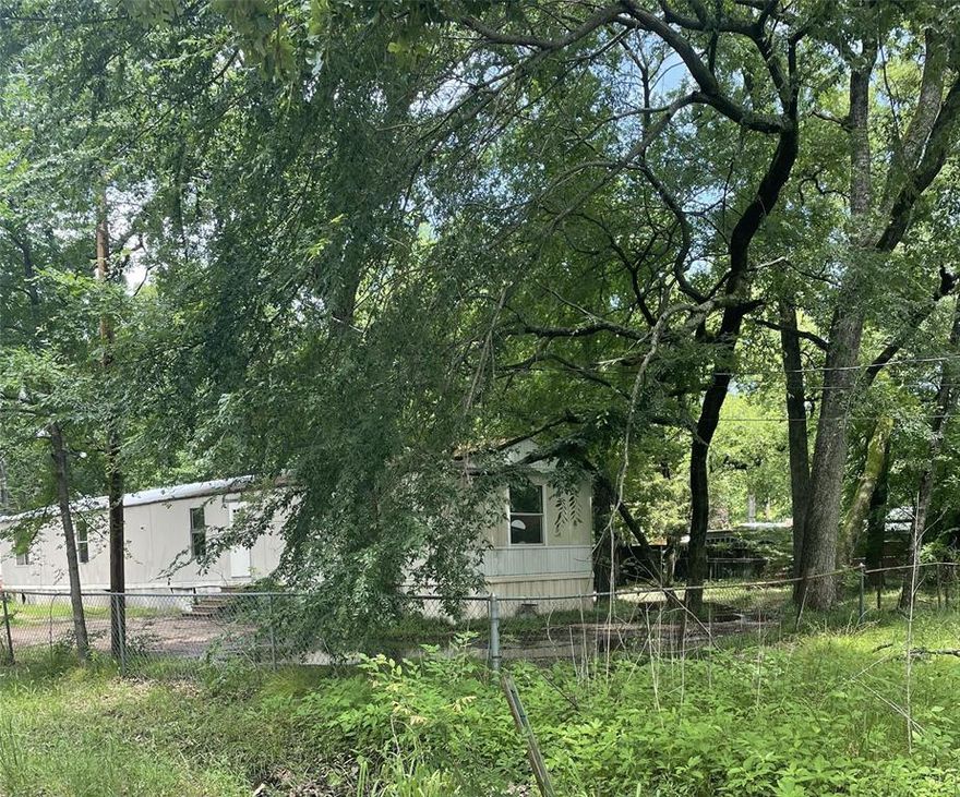 0.2932 acre lot with nice trees. Property currently has a singlewide home on it. Not aware of the condition of the home. Home could be removed or possibly fixed up.