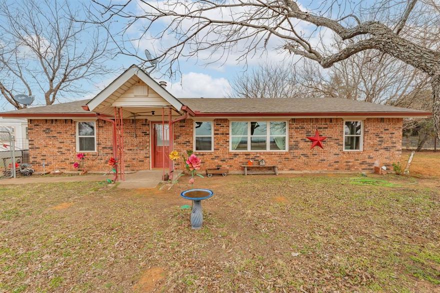 Very impressive, well-maintained, 3 bedroom, brick Country Home on 3.08 acres m-l, located outside of the city limits just south of Graham near the Brazos River Bridge; This super-charming home features a plethora of custom amenities such as an open concept living, dining and kitchen; Luxury, water-proof vinyl plank flooring throughout, ceiling fans throughout, new natural gas line from the house to the road, newer, white kitchen cabinetry, Corian style countertops, under-cabinet lighting, lazy Susan, double sink, dishwasher, refrigerator, vent-a-hood & spacious walk-in pantry; Cute sunroom for house plant lovers and nature lovers who enjoy a serene space for enjoying their morning coffee while spotting an occasional deer; Central Heat & Air with natural gas heat and electric air along with a few natural gas wall heaters in various rooms; Attic fan; Spacious hall bathroom boasting a step-in, oversized shower, extra-large vanity with sink & make-up area & toilet; Split bedroom arrangement; Primary bedroom has a half bath offering a vanity with sink and an elevated toilet; Well-appointed laundry room with washer & dryer connections; Two car oversized detached shop-garage combo is 24' X 28' with concrete slab, electricity and remote controlled doors with a side walk-thru door; The additional one-car metal garage is 22' X 15'; The RV Port is negotiable depending on offer; The metal barn on concrete slab is 20' X 16' and offers ample storage for your tractors, boat or ATVs; A functioning 65' water well is located in the handy Wellhouse-Garden Shed with concrete floor, a new well pump and control box; Electrical updates including some updates in the attic and a newer panel box; New windows; Covered patio with wood decking and brick pavers; Rain gutters; Security lighting; Perimeter fenced with hog panel lowers and 2 strand uppers; Cross fenced; Double gate entrance; Dog run; Out-in-the-country vibes but close to town; Must see!!