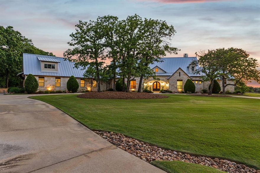 Discover a truly exceptional lifestyle in this meticulously crafted ranch estate, set on over 6 serene acres at the end of a quiet cul-de-sac in the prestigious Bartonville community. This home offers four spacious bedrooms, each of the three downstairs bedrooms boast a private ensuite bath, including a guest suite with a handicap-accessible hall, room and bath for unmatched comfort and convenience. Thoughtfully planned for both grand entertaining and intimate family living, the residence features two generous living areas, a dedicated upstairs game room, and soaring ceilings that create a sense of openness and sophistication. For those who value security and peace of mind, the property includes a built-in tornado shelter or safe room and a whole-home generator, ensuring you are always prepared. Car enthusiasts will appreciate the four-car attached garage with a spacious unfinished room above the garage ready for you to make it your own, as well as a fully insulated and foamed eight car plus car barn (detached garage) with an RV bay. This additional structure is more than just a garage, it includes a carport, large patio, and a kitchenette, making it perfect for projects, entertaining, or secure storage for your prized collection. Outdoor living is elevated to a new level, with a covered back porch overlooking a picturesque pond, complete with a cozy fireplace for crisp Texas evenings, a firepit for gatherings, and a refreshing saltwater pool for relaxing summer days. The entire home is professionally foamed for superior insulation and energy efficiency, reflecting the highest standards of craftsmanship.  A private well for irrigation and pool ensures that you can water in the Texas heat. With award winning Argyle schools nearby, miles of horse riding trails and natural beauty at your doorstep, this estate offers an unparalleled combination of privacy, luxury, and convenience, the ultimate Texas retreat. This is a must see estate, truly a one of a kind Texas home!