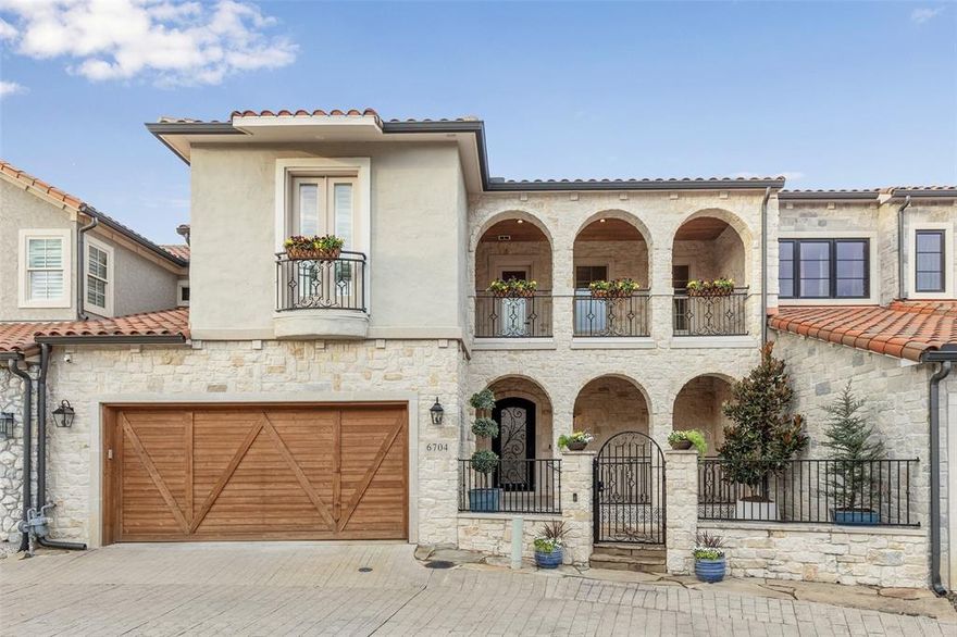 Located in the heart of Stonebridge Ranch in Adriatica Village, this beautifully appointed home blends timeless European charm with thoughtful modern upgrades. A private gated courtyard welcomes you into a refined interior featuring rich wood flooring, Austin stone accents, and custom ironwork along the staircase and railings. The spacious living room has a floor to ceiling stone wall fireplace, and is open to the dining and kitchen for seamless entertaining. The kitchen features Thermador stainless steel appliances, Taj Mahal quartzite countertops, striking Magical Forest Cinnamon glass tile backsplash, an induction cooktop, also plumbed for gas, and double convection ovens, ideal for both everyday living and entertaining. With 4 bedrooms, 3 full baths, and 1 half bath, and a large hidden flex room,  the floor plan offers flexibility and comfort. The half bath includes reinforced walls for added shelter, and the garage is equipped with a 20 Amp EV charger and has epoxy flooring. Outdoor living features a covered patio, built-in outdoor grill, and charming courtyard spaces. Adriatica Village is known for its cobblestone streets, water views, and vibrant walkable lifestyle, offering shops, restaurants, wine bar, Starbucks, UPS, salons, offices, and medical services just steps from your door. A rare opportunity to enjoy luxury living with unmatched character and convenience in McKinney.