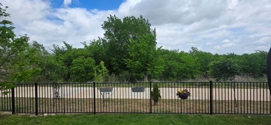 You’ll find refined suburban living in this beautifully maintained 4-bedroom, 3-bath residence nestled in a quiet northwest Fort Worth community. Built in 2019, this thoughtfully designed home showcases new carpet with upgraded Lifeproof padding, luxurious quartz countertops, custom painting throughout most of the home, expansive living spaces, exceptional closet storage, and a modern gas fireplace that turns on with the flip of a switch—offering both comfort and functionality with contemporary style. Backing directly to a tranquil greenbelt with no rear neighbors, the property provides a rare blend of privacy and connection to nature, along with direct access to neighborhood walking and biking trails. Wide sidewalks enhance the walkable feel of the community, while the backyard offers a peaceful retreat for relaxation or entertaining with serene nature views. Situated within the highly regarded Eagle Mountain-Saginaw Independent School District, including Copper Creek Elementary located INSIDE the community, and just minutes from Alliance Town Center, residents enjoy effortless access to shopping, dining, and daily conveniences. Nearby local favorites such as Hobby Lobby, Mardel, and Lupe Tortilla are just moments away, along with a variety of additional dining & entertainment options. The active HOA elevates the lifestyle with community events, visiting food trucks, a cool and refreshing resort-style pool, basketball court, amenities center, three maintained green spaces, a neighborhood park, and a serene hidden nature cove complete with a small waterfall. The neighborhood is known for its welcoming atmosphere and is especially festive during trick-or-treat season, creating an inviting environment that truly feels like home. With modern construction, scenic surroundings, exceptional community amenities, and an unbeatable location, this property offers not just a home—but a whole new lifestyle. Is this your perfect match?