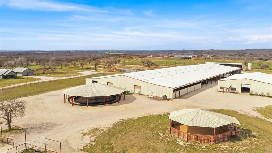 Approximately 96 acres of Parker county sandy loam. 
Endless possibilities with the future of this property. Continue on as a breeding facility, also able to offer show fitting. Build a big indoor arena next to the mare motel and you’ll have one of the finest show facilities in the area. 
The mare barn offers 130 concrete tilt wall stalls 14 feet by 20 feet with automatic waterers. There are six stocks, a two bedroom two bath two-story apartment in the building, a additional office or apartment space, full aqua tread therapy, covered parking for more than a dozen trailers, hay storage, huge wide concrete hallways, bathroom and vet lab. 
The stallion barn offers seven concrete tilt wall stalls that measure 14 feet by 30feet with automatic Waters. Also in the stallion barn is a full-size office roughly 30 feet by 30 feet, full lab, vet room, breeding room, concrete hallways, and fully enclosed. 
There is a commodities building behind, conveniently located to store, massive amounts of hay, feed, and shavings. Building measures 50 feet deep by 125 feet across.
Newly constructed covered walker and covered round pen with viewing box.
Huge pipe paddocks all along the roadway, big piped in pastures throughout the property.
Full size rodeo arena with four bucking chutes, and two full size roping boxes with return alley and a calf roping lane with boxes down the entire west side.
There’s also 180 feet round pen with great ground amd wrapped in cedar staves.
There is also a detached frame home with two bedrooms, one bath and two car garage.
Plenty of ground water with six ponds and scattered oaks throughout the property. 
Majority of the pastures are in coastal Bermuda.
There are roads throughout the property and paved highway frontage. 
Build a new piece of history in this already historic location.