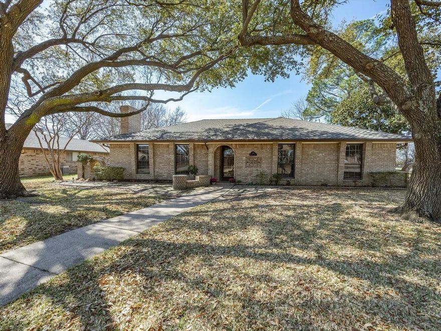Tucked into a beautiful, well-established neighborhood with mature shade trees and minimal through-traffic, this meticulously maintained home offers comfort, space, and timeless charm. Situated on a generous corner lot just shy of a quarter acre, the property features 1,723 square feet, 3 bedrooms, and 2 full baths. Inside, you’ll find a thoughtfully updated interior with kitchen and bathroom upgrades completed within the last 10 years, offering modern touches while maintaining the home’s inviting character. The majority of the home showcases durable laminate wood flooring and tile, while brand new carpet adds fresh comfort in two of the bedrooms. The living area is anchored by a cozy wood-burning fireplace with electric logs and optional blower function. Outside, the property continues to impress with a two-car garage and a separate workshop complete with additional storage space—ideal for hobbies, projects, or extra storage needs. With its quiet location, mature trees, spacious corner lot, and pride of ownership throughout, this home is a rare opportunity in a highly desirable neighborhood. Move-in ready and exceptionally cared for, it’s ready to welcome its next owners.