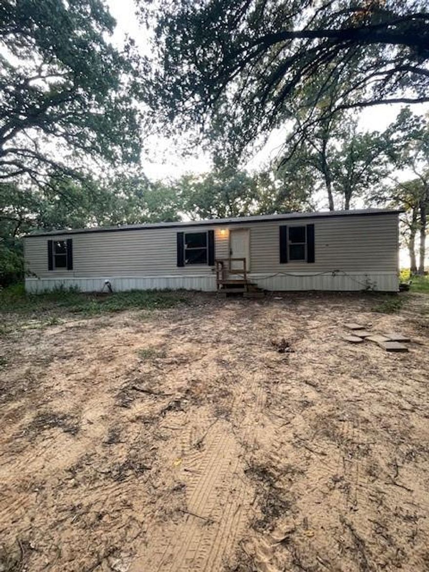 If you want acreage this is for you. A great starter home on 2.616 acres. Home is a cute 3 bedroom 2 bath 16 x 60 single wide mobile home on property. It's been recently remodeled. Vinyl Plank Flooring. Central heat and air. Enough room to put another Mobile or build a home if approved by the city.   Property has been re-platted is Lot 1 with 2.616 acres with land to roam. See the re-plat in the Transaction desk. Composition Roof replaced in January of 2024.The mobile home was manufactured 11-22-2016 and was completed in 2017 year built and Square Footage is per the paperwork on the mobile home when it was purchased. The mobile home on the tax records are incorrect as well as age. There is value in the land that is part of the property.  All information is deemed reliable but is not guaranteed. Buyers agent & buyer to do due diligence to check all information including schools, Sq footage and checking with the city if moving another mobile home or building another home on part of the property.  The Seller's Disclosure and The On-site sewer facilty addendum is in the Transaction Desk. The Re-Plat is also there to print.  Please print it all from the Transaction Desk.