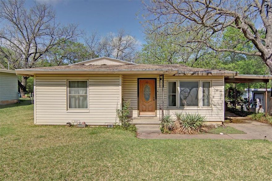 Three bed, two bath home with storage shed accessible through covered breezeway on a nice-size lot with large trees in established neighborhood.