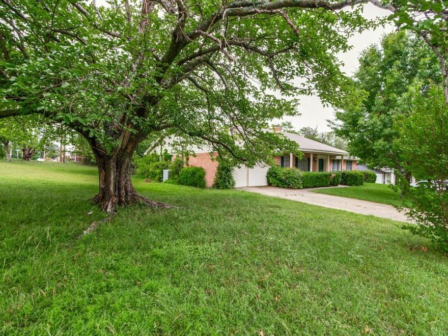 Embrace the potential of this 4-bedroom, 2-bathroom, 2 car garage gem situated on a sprawling corner lot in Benbrook. This home offers the best of calm, peaceful country living while keeping city conveniences within reach. It is a prime opportunity for investors or buyers ready to build instant equity through a cosmetic makeover. The interior features a formal dining room and a versatile secondary living area upon entry, leading to a main family room anchored by a large brick fireplace and custom built-ins. The layout includes a private primary suite with an ensuite bath, while the fourth bedroom makes for a perfect secluded office. Step outside to a massive backyard featuring an oversized covered deck and a bonus storage shed for all your tools and hobbies. Location is the standout feature here—you are just a 5-minute walk from the shores of Benbrook Lake for hiking and fishing, yet minutes from I-20 and Loop 820 for an easy commute to Fort Worth and Clearfork. If you’ve been looking for a large lot with great bones to make your own, this is it!