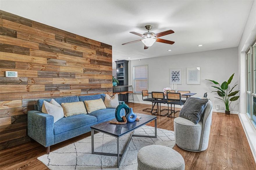 Rare opportunity to get into highly desirable Lochwood for under $425K—most homes here sell in the $600Ks. This beautifully maintained mid-century modern features rich wood flooring throughout, no carpet, and a striking wood accent wall that sets the tone the moment you enter. The updated kitchen includes white cabinetry, granite countertops, stone backsplash, stainless steel appliances, and a custom island with wine fridge, storage, and bar seating. Major improvements include electrical panel and breakers (2025), Low-E windows, updated lighting, high-efficiency HVAC (2020), roof (2020), new garage door opener (2024), EV charging outlet, gas-compatible appliances, and Ring security system. The spacious backyard offers lush grass, a newer fence, and room for pets or gatherings. Enjoy walkability to Lochwood Park with new pickleball courts, wooded walking trails, tennis courts, and playgrounds. Minutes from White Rock Lake, Dallas Arboretum, Lakewood, Lower Greenville, Casa Linda, and Lake Highlands. Located across from the brand-new Martha Turner Reilly Elementary with enhanced campus security. Perfect opportunity for buyers wanting style, updates, and long-term appreciation in one of East Dallas’s most loved neighborhoods.