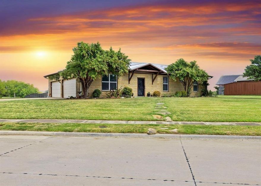 Lakefront luxury on approximately 1.3 acres with direct access to Lake Lewisville. This custom-built home is tucked into the quiet Cottonwood Point community, offering a private setting with beautiful water views, unforgettable sunsets, and nearby walking trails that enhance the outdoor lifestyle.
The open-concept floor plan is designed to maximize natural light and showcase the lake. The living area features oversized windows, a stone fireplace, wood-look tile flooring, and energy-efficient spray foam insulation.
The kitchen includes granite countertops, a large island, custom wood backsplash, and ample cabinetry for storage and functionality.
The primary suite offers direct patio access and lake views, creating a relaxing retreat. Outdoor features include Trex-style decking and a retractable patio cover, ideal for entertaining or enjoying sunset views.
Additional features include a four-car garage with 220-volt power, providing space for vehicles, storage, or workshop use WITH heating and AC.
Enjoy convenient access to boating, fishing, nearby trails, dining, and entertainment, all within a short drive to Frisco and PGA Headquarters.