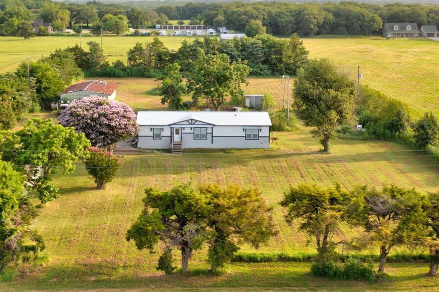 AMAZING Opportunity to invest in a piece of heaven in Pilot Point.  This is a 2-plus-acre land with a 3-bedroom 2-bath home nestled in the heart of Pilot Point with a built-in monthly income.  The current lease is in effect until the end of February 2026.  Pilot Point's population is experiencing rapid growth, with projections indicating an increase from 7,507 to over 10,144 by 2029. The city's population growth has surpassed 25% annually in recent years, placing it among the fastest-growing communities in North Texas.  So invest now while it's still affordable and allow your investment to grow every year.  OR let your imagination go to work and build your retirement home.  Very short drive to the lake and boat dock, minutes from Downtown shops and restaurants.