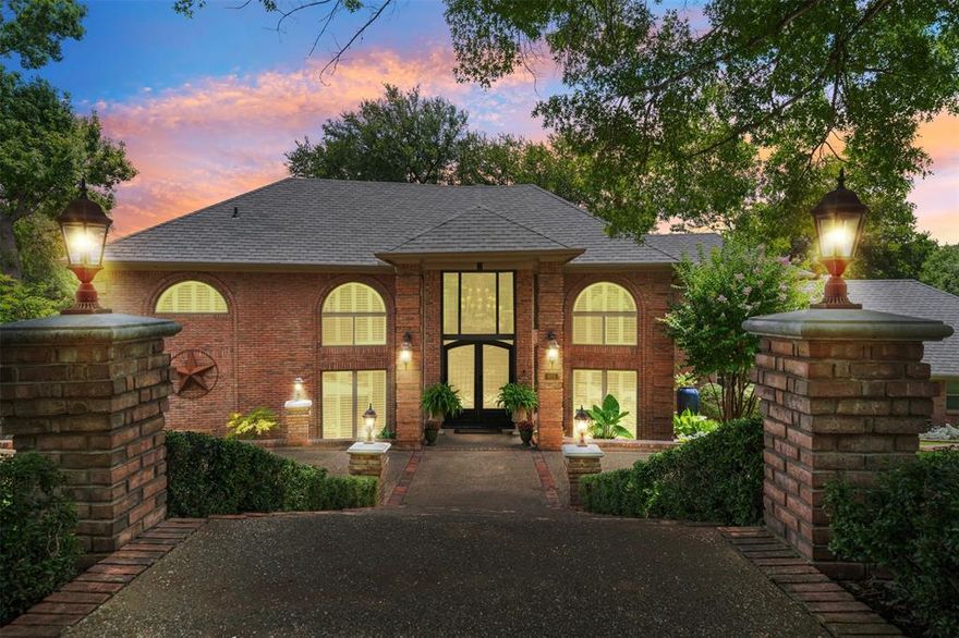 Welcome to one of Fort Worth’s most breathtaking properties, nestled on a premium lot backing to a serene, tree-lined greenbelt with a natural creek. This showstopping residence offers luxury, space, and privacy with features designed for both everyday living and impressive entertaining. From the moment you step onto the marble floors in the grand two-story foyer, you're greeted by a dramatic split staircase and a sense of timeless elegance. The expansive great room boasts rich wood-look porcelain tile flooring, a striking fireplace, and an 18’ high wall of floor-to-ceiling windows that showcase panoramic views of the lush backyard, sparkling saltwater pool, and wooded landscape beyond. The formal dining room seamlessly connects to a gourmet kitchen with a large breakfast area, perfect for casual meals or morning coffee. The private owner's wing includes a spacious bedroom, cozy sitting room, and a spa-inspired bathroom with heated floors, an oversized walk-in closet with custom built-ins, and even space for a personal coffee bar in the dressing room. Upstairs, enjoy a generously sized game room complete with a wet bar and half bath—ideal for hosting guests. Three additional bedrooms, two full bathrooms, and a versatile bonus room (perfect as a media room or home gym) provide ample space for family or visitors. Enjoy incredible views from not one, but two upper-level balconies. Two covered patios on the main level offer shaded outdoor spaces for relaxing or entertaining. The beautifully landscaped grounds and resort-style saltwater pool create a tranquil oasis that feels miles away from the city—yet you're conveniently located in the heart of Fort Worth. Additional features include a three-car garage plus a tandem fourth bay for extra storage or workspace. This one-of-a-kind property truly has it all. Schedule your private showing today and experience the beauty and serenity for yourself!