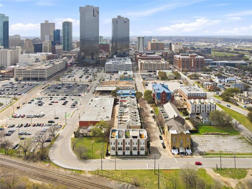 Freshly positioned and ready to impress in the heart of downtown Fort Worth! This sleek 3-story modern townhouse places you just minutes from Sundance Square, Fort Worth's Museum District, Fort Worth Stockyards, and the exciting Panther Island development—offering the perfect blend of city energy and sophisticated living. The open-concept main living space features gorgeous wood flooring, quartz countertops, rich mahogany cabinetry, and stainless steel appliances, creating a clean and contemporary aesthetic.  Smart home features add convenience and efficiency, making everyday living seamless. With 2 spacious bedrooms and 2.5 stylish baths, the layout is ideal for both comfortable living and entertaining. Enjoy morning coffee or evening sunsets from your private balcony, or take the experience to the next level on the private rooftop deck with stunning Fort Worth skyline views. The oversized tandem garage accommodates up to three vehicles, a rare and valuable feature for downtown living. Whether you're enjoying the vibrant restaurants, nightlife, and entertainment nearby or relaxing in your own modern retreat, this home offers the ultimate lock-and-leave urban lifestyle in one of Fort Worth’s most dynamic locations.
