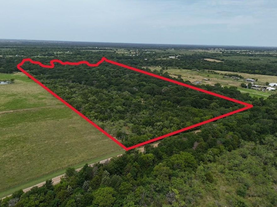 Here's your opportunity to own an exceptional 41.22-acre property made up of three adjacent lots in the peaceful countryside of Kemp, Kaufman County. Tucked away just off County Road 4031, this scenic tract is heavily wooded, offering privacy, natural beauty, and a quiet setting. A drainage ditch adds character to the landscape. The smaller lot includes a rustic old home and barn, which can be restored or cleared for new use. Barbed wire fencing surrounds this portion, with gated access serving as the main entry point to all three parcels. Zoned Residential with no HOA, this flexible land allows mobile homes, single-family homes, or barndominiums. Water, electricity, and an existing septic system are available, saving time and costs.