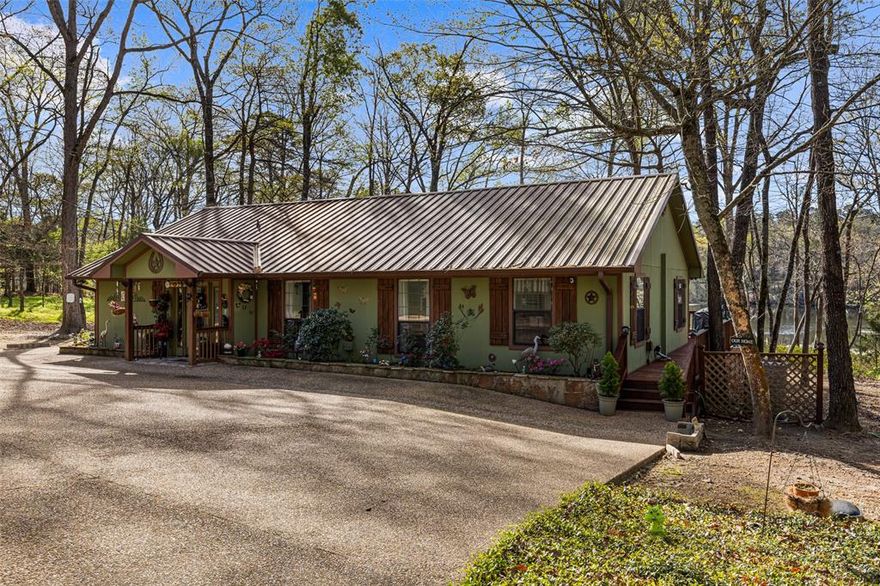 Gorgeous Waterfront Home on beautiful Horseshoe Bend Lake, nestled in the heart of the East Texas Piney Woods. This spacious residence features 3 bedrooms and 3 baths, providing ample room to relax. The large den, dining room, kitchen, primary bedroom, and second bedroom all adorned with large plate glass windows, allowing you to enjoy natural sunlight and peaceful lake views. The den area boasts vaulted ceilings and a cozy gas log fireplace, which seamlessly connects to the dining and kitchen areas. Quite ideal for hosting family and friends. The gourmet kitchen features granite countertops, drop in stove top, built in oven, dishwasher, microwave, and trash compactor. The spacious primary bedroom includes a comfortable sitting area offering breathtaking views of the lake, and direct access to a private screened-in porch, complete with hot tub. The primary bath is a retreat in itself, also with a soaking tub, walk-in shower, and two separate vanities. The primary closet conveniently adjoins the washroom and office area. The home offers durable flooring throughout, producing easy and relaxed living. Step outside to an outdoor oasis with an enormous open deck for entertaining while enjoy spectacular sunsets. Other key outdoor features include a gas fire pit, and deck that is leading to the fishing pier and boat dock. The home has durable Hardy Board (concrete) siding, concrete driveway, and a separate 4 bay garage allowing space to work, or store all your special toys. And the property also has RV pad with electric and water, a greenhouse and storage building. Just too much to list. Fiber optic is also available for your internet needs. With so much to offer, this stunning waterfront property is calling your name. Don't miss your chance to experience the serene lifestyle of Horseshoe Bend Lake.