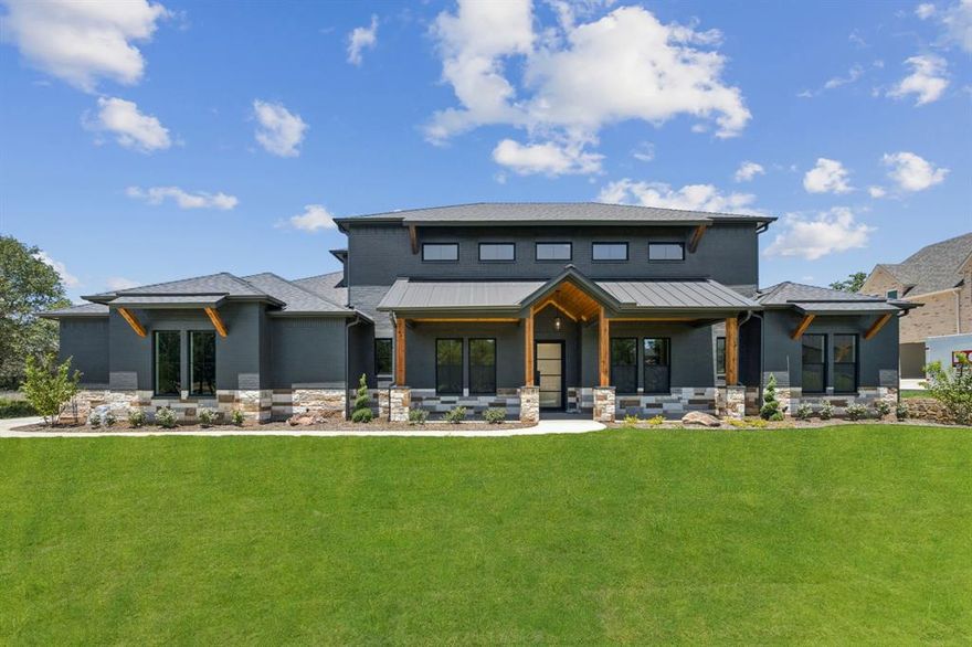 Experience refined country living in this newly completed custom estate, perfectly situated behind the gates of the prestigious Estancia at Weatherford. Set on over an acre, this brick and stone showpiece offers timeless architecture, luxurious finishes, and the serenity of wide-open spaces just minutes from Downtown Weatherford and a short drive to Fort Worth. A sweeping Texas-sized front porch welcomes you into a home where every detail has been thoughtfully curated, from the soaring cathedral beamed ceilings and rich hardwood floors to the dramatic stone fireplace flanked by custom built-ins. The chef’s kitchen is both stunning and functional, featuring an oversized island, gas cooktop with pot filler, designer lighting, and a butler’s pantry ideal for entertaining. The private study provides the perfect work-from-home retreat, while the expansive game room, with en-suite bath, wet bar, and patio access, offers the ultimate space for relaxation or hosting guests. The secluded primary suite is a true sanctuary, boasting a spa-inspired bath with a freestanding tub, double-entry shower, dual vanities, and an oversized walk-in closet. Spacious secondary bedrooms, fresh hydro-mulch across the entire property, a well-appointed utility room with custom cabinetry, and a three-car garage featuring sleek epoxy floors complete this thoughtfully designed home. The oversized backyard is a blank canvas ready for your dream pool, outdoor kitchen, or sports court. This is more than a home, it’s a lifestyle of luxury, privacy, and convenience in one of Weatherford’s most sought-after communities.