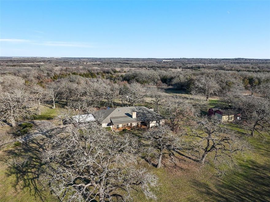 This is your opportunity to own a rare 18.29 acres in Burleson with a 3100 sq ft home! This home is situated towards the back of the property and features an electric gate which makes it more private. Upon entry you will find a very large living area complete with wood burning fireplace and plenty of room for everyone! Kitchen is large and features a breakfast area with large bank of windows. Breakfast bar, built ins, & such a great space to prepare meals! The primary features 2 full baths and is very large both with walk in showers and one bath has a giant walk in closet. Each secondary bedroom has its own bath. Office by front entry is perfect for paying bills or working from home! The acreage is heavily treed and an additional 2700 sq ft building for storage or workshop and has electricity! This home has so much potential and it faces FM 731 so there is possibility portions could be rezoned commercial!