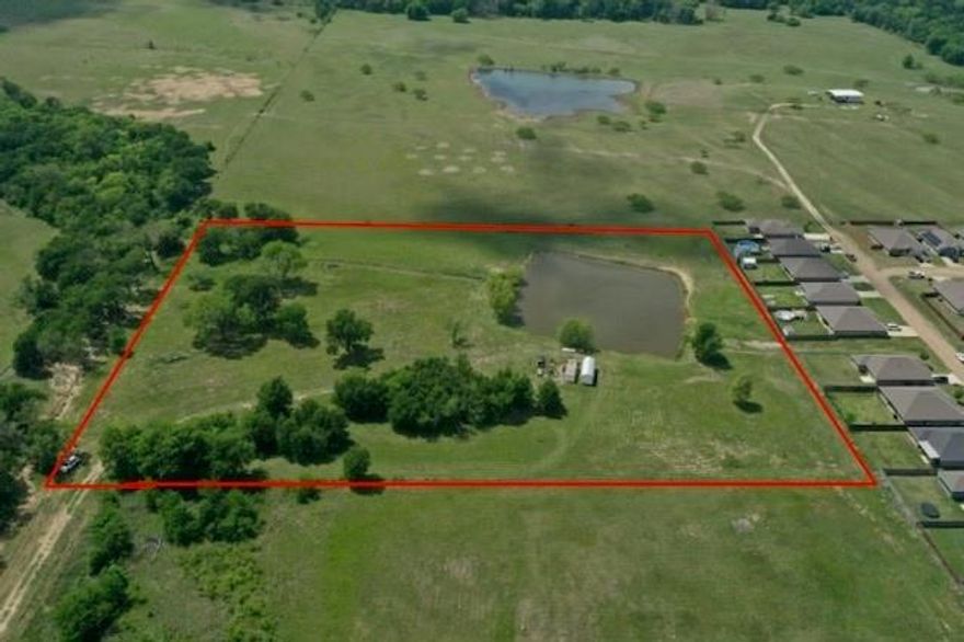 Discover a unique and rare opportunity to own 8.22 acres right in the heart of town! This exceptional property offers the perfect blend of privacy and convenience, featuring a fully stocked pond fed by a small creek, complete with a charming small bridge that adds to the property’s character. The land is mostly fenced and includes a shop, making it ideal for a variety of uses. Whether you’re looking to build your dream home, create a private retreat, or explore an investment opportunity, this property offers endless potential. Enjoy peaceful country-style living with the convenience of being close to town—truly the best of both worlds!