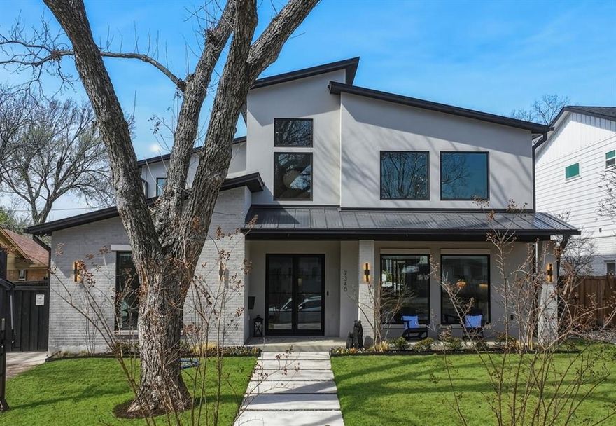 Zoned to Lakewood Elementary, this architecturally striking residence sits on an oversized lot and showcases a thoughtful, well-designed layout ideal for both everyday living and effortless entertaining. Large windows fill the home with natural light, highlighting the stunning designer tile selections, elevated lighting, and clean architectural lines throughout. The main level offers incredible entertaining spaces with soaring 20’ ceilings in the living and dining areas, a private office with custom built-ins, and a luxurious primary suite. An additional downstairs bedroom provides flexibility as a secondary living space, guest suite, or second office. The kitchen is a true centerpiece, featuring designer finishes, stainless steel appliances, a built-in refrigerator, wine fridge, refrigerated drawers, and an oversized island that anchors the open-concept living space. Upstairs, three generously sized bedrooms each feature ensuite baths, along with an additional office or homework area perfectly suited for today’s lifestyle needs. Outdoor living is equally impressive with a covered patio with automatic screens overlooking the sparkling pool and spa, custom finished pool decking, and a low-maintenance turfed yard designed for year-round enjoyment. Additional highlights include wood floors throughout, smooth finish walls, a whole-home generator, mosquito misting system and a pool cooler for warm Texas summers. An attached oversized two-car garage provides ample room for storage and functionality. This exceptional Lakewood Elementary home blends sophisticated design with comfortable, livable spaces — a rare opportunity not to be missed.