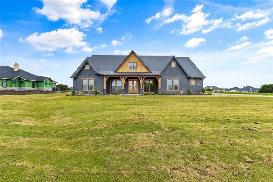 WINNER OF THE 2023 HOOD COUNTY SHOWCASE OF HOMES!! Experience luxurious living in this stunning new home on 1 acre in Starlight Ranch. This home features 4 bedrooms & 2.5 bathrooms with walk-in closets, large double doors & a view into the expansive living room, kitchen & adjacent outdoor area. High-beamed ceilings & large glass in living room looks out over a massive outdoor living space, complete with fireplace & outdoor kitchen. There are also electric operated screens, great for privacy & insect control! Kitchen features 48” dual fuel range with 8 burners & 2 ovens, quartz counters & large island with space for stools. Utility Room with plenty of storage, sink & pet washing station. Master Suite boasts vaulted beamed ceiling, His & Her closets & double doors leading to a private, covered patio. Upstairs features huge game room, movie theater room with built-in snack bar! Attached is an oversized 2 car garage & 3rd detached, fully finished 20x30 garage. Built by Double Rock Homes.